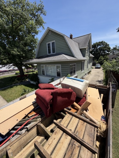 Truck loaded with old furniture and a couch during a West Michigan home cleanout