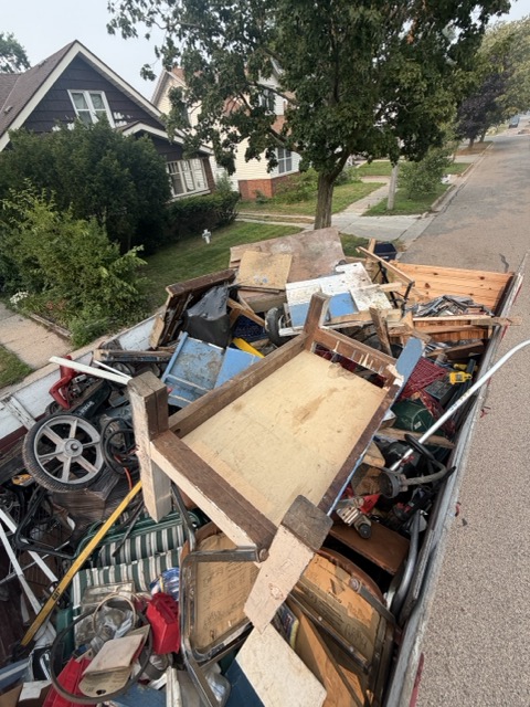 Dump truck loaded with junk and debris during a Holland, MI junk removal job
